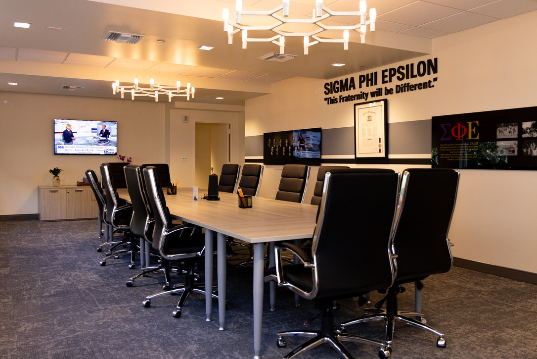 The Founders Conference Room, set with a long conference table under the Sigma Phi Epsilon motto