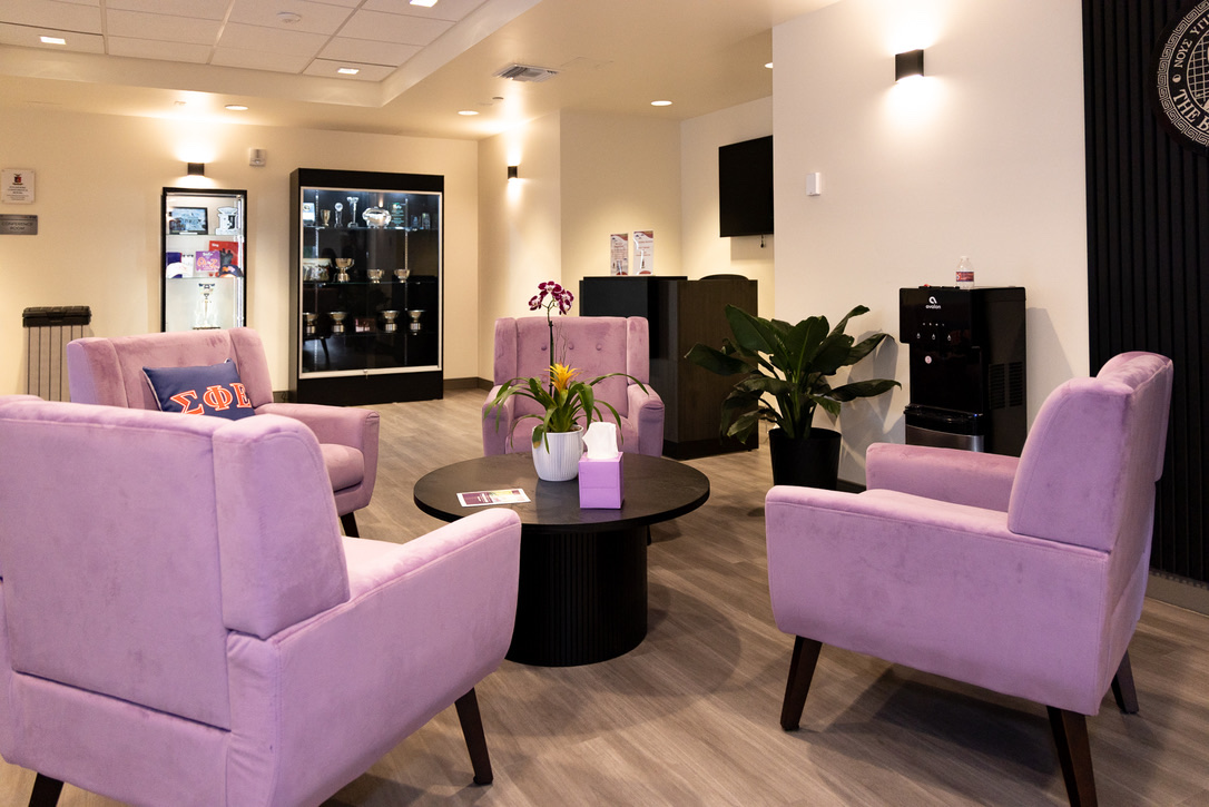 The common area, with armchairs around a low table and the trophy case behind