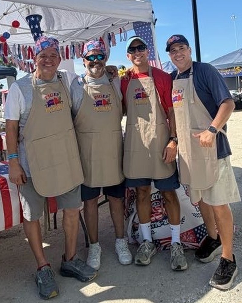 Frank Peña, Fran Oses, Alain Guerra and Danny Diaz in PigEp aprons under the team tent